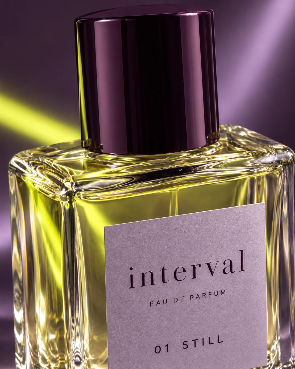 Macro view of the plum perfume cap, clear glass and textured lilac INTERVAL label